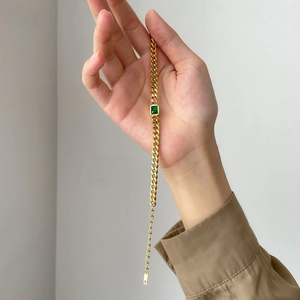 Gold Cuban chain bracelet with emerald green rectangular gemstone and adjustable tail