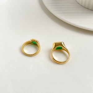 Detail of square emerald zircon rings with gold-plated textured and smooth bands