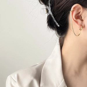 Minimalist gold double piercing earrings with CZ chain connecting ear cuff and hoop