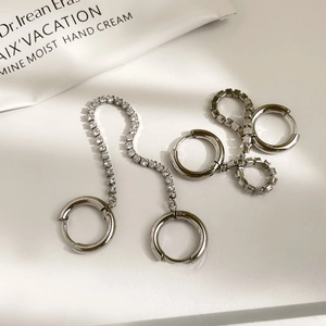 Silver double hoop earrings with cubic zirconia chain on minimalist white background