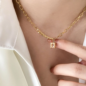Close-up of elegant gold chain necklace featuring a square zircon pendant for women