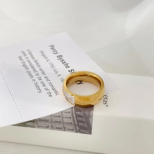 Detailed macro of gold plated ring with square zircon and 925 silver hallmark