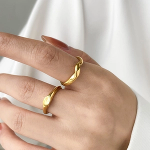 Polished gold geometric wavy twist rings set for women displayed on a model