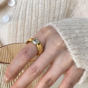 Gold plated stainless steel ring with rectangular zircon shown on a knits-wear model