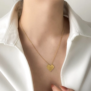 Golden pixel heart necklace with white enamel pattern on a delicate chain for women