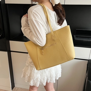 Large vintage yellow tote bag in lychee pattern leather shown on model for daily commute