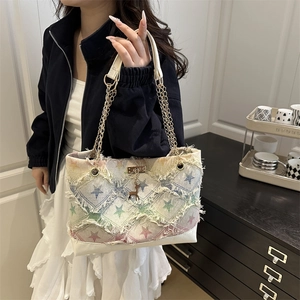 Vintage denim underarm tote with colorful star patterns, chain strap, and deer charm
