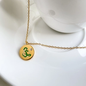 Gold-plated titanium steel necklace with green enamel round pendant and star stone