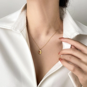 Elegant gold titanium necklace with red enamel rose pendant and cubic zirconia accents