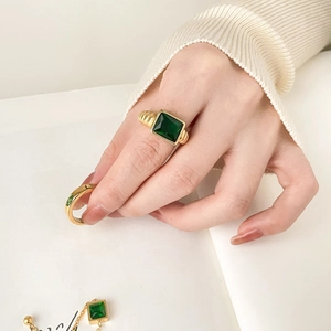 Vintage gold ring with rectangular emerald stone and matching minimalist band on model