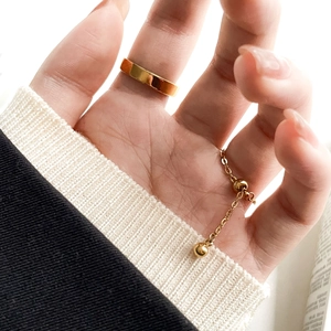 Detail of emerald zircon chain rings worn by model for elegant everyday styling