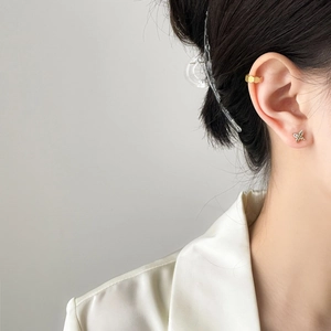 Golden butterfly zircon stud earrings and geometric honeycomb ear cuff on model