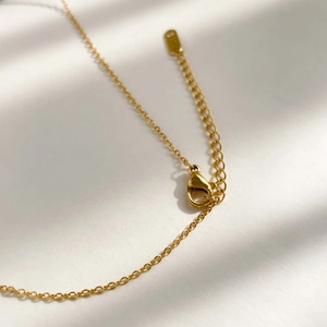 Detail of the gold zircon necklace lobster clasp and adjustable extension chain