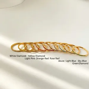 Detailed row of slim gold titanium rings featuring vibrant multi-colored zircon stones