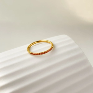 Detailed macro view of gold plated titanium steel ring with vibrant red zircon inlay