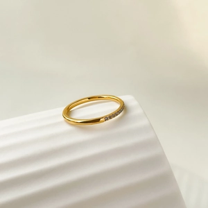 Macro detail of gold plated titanium steel ring with rows of sparkling zircon stones