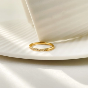 Macro shot of 18K gold plated titanium ring with half-circle micro-inlaid cubic zirconia