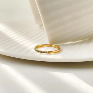 Macro detail of gold plated steel ring featuring a row of pavé set black zircon stones