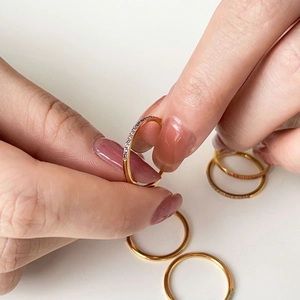 Slim gold plated titanium steel ring featuring a row of vibrant purple cubic zirconia