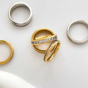 Macro shot of 18K gold and silver plated titanium rings with pavé set crystals