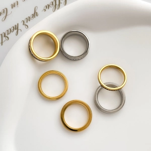 Detailed set of titanium steel rings in gold and silver with zircon stone inlay on tray