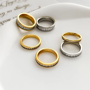 Detail of 18K gold and silver plated titanium steel rings with full pavé zirconia inlay