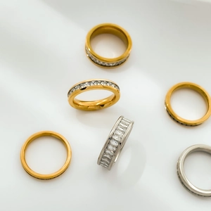 Detailed view of silver and gold eternity bands featuring rectangular cubic zirconia stones