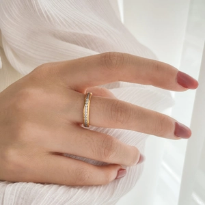 Detail of 18K gold plated eternity ring with channel-set sparkling stones on hand