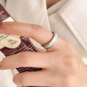 Close-up of silver titanium steel ring with full rectangular-cut cubic zirconia inlays