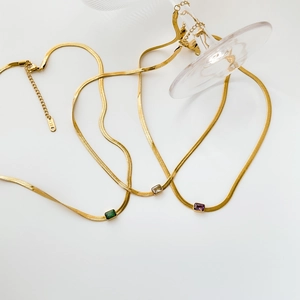 Flat snake bone chain necklaces featuring emerald, clear, and purple zircon rectangle pendants