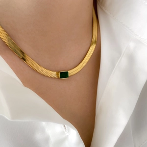Elegant gold herringbone snake chain necklace with a green rectangular zircon pendant