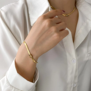 Elegant gold snake chain necklace with square zircon worn by model in white shirt