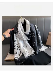 Detail of silk-like camellia scarf with black and white patterns and grid texture