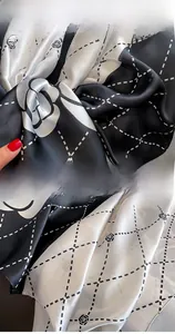 Detail of silk-like scarf showing premium edge stitching and elegant rose floral pattern