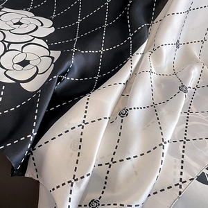 Detail of silk scarf showing camellia floral pattern and quilted texture on fabric