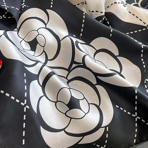 Detail of silk scarf showing camellia flower pattern and quilted geometric texture