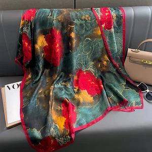 Elegant silk-like scarf with Chinese peony print on leather background with fashion props