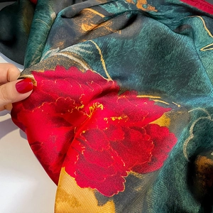 Elegant silk-like floral scarf in dark green and red satin with decorative yellow trim