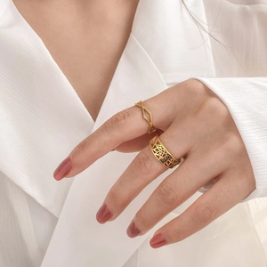 Minimalist gold hollow geometric rings set shown on hand with elegant white blouse