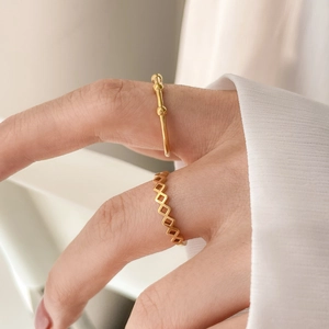 Stackable 18K gold rings with geometric hollow pattern and minimalist beaded band design