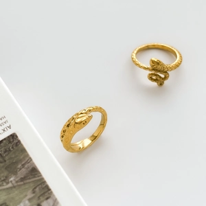 Close-up of golden vintage punk snake rings with detailed scales and wrap-around design