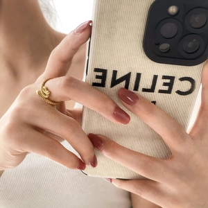 Close-up of vintage punk gold snake wrap ring featuring intricate scale textures on finger