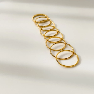 Set of 10 minimalist stackable gold rings with polished finish and subtle textures