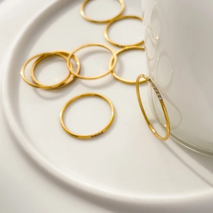 Macro shot of gold-plated minimalist stacked rings with sparkling pavé cubic zirconia
