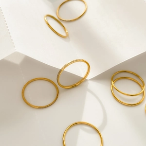 Close-up of a stacked gold ring set featuring delicate pavé crystals and polished bands