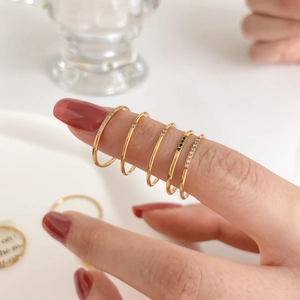 Five-piece minimalist gold stacking ring set with sparkling white and black zircons