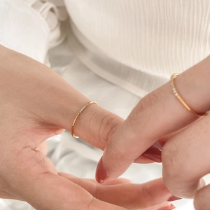 Slim gold stackable rings with delicate diamonds set on minimalist thin bands for women