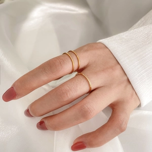 Elegant gold stacking ring set with sparkling zircon micro-pave crystals on white satin