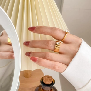 Detail of gold plated rings featuring a large round zircon and a heart shaped crystal