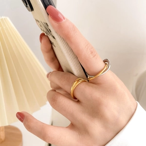 Dual-tone linked ring set with gold textured band and interlocking silver metal rings